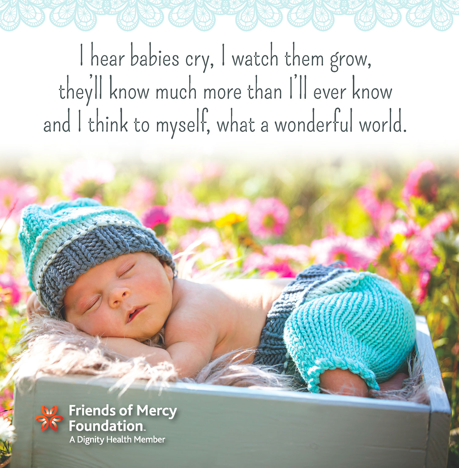 Infant sleeping outside with flowers behind him